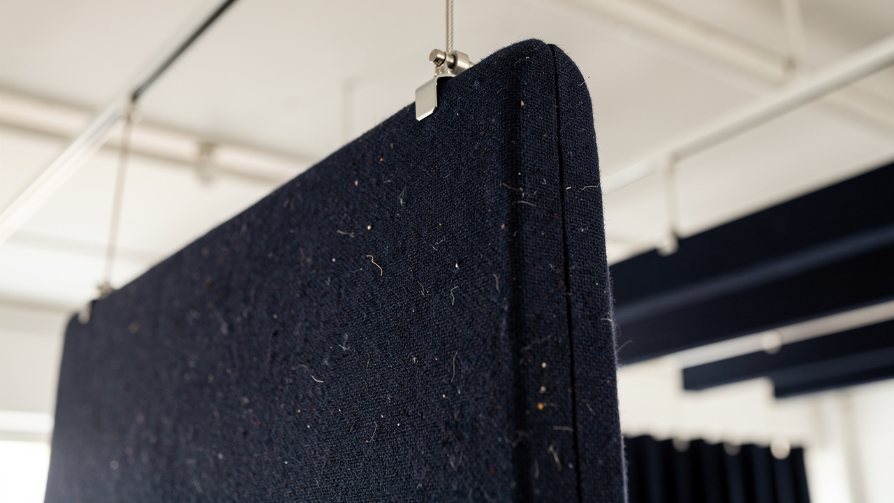 Close-up of fabric-wrapped acoustic baffle panel texture