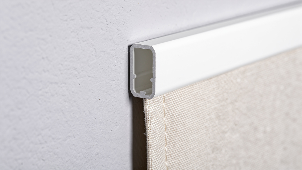 Close-up of PVC profile track gripping acoustic fabric edge